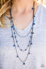 Load image into Gallery viewer, A glistening gunmetal chain gives way to layers of gunmetal chains featuring blue pearls. Varying in shape and shimmer, the mismatched chain drape across the chest in a refined fashion. Features an adjustable clasp closure.  Sold as one individual necklace. Includes one pair of matching earrings.  