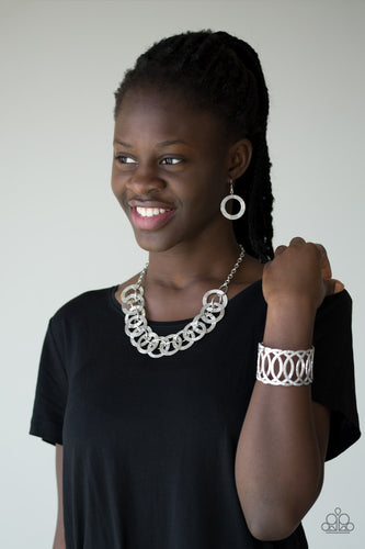 Necklace and Earrings:  Etched and hammered in linear and diamond-cut shimmer, glistening silver circles interlock into a bold industrial chain below the collar. Features an adjustable clasp closure  Bracelet:  Etched and hammered in linear and diamond-cut shimmer, glistening silver circles join into a dramatic cuff around the wrist.  Sold as one individual necklace, set of earrings, and a bracelet