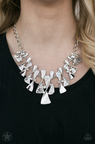 Twisted silver hourglasses dance along a chunky silver chain with tiny clear rhinestones adding sparkling, elegant accents. Beautiful textured pieces add depth to the design. Features an adjustable clasp closure.   Sold as one individual necklace. Includes one pair of matching earrings.  Always nickel and lead free.  Blockbuster