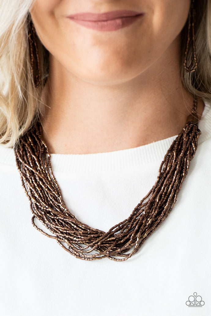 Strands of copper seed beads subtlety twist below the collar, coalescing into a blinding shimmer. Features an adjustable clasp closure.  Sold as one individual necklace. Includes one pair of matching earrings.  Always nickel and lead free.