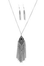 Load image into Gallery viewer, A black bead is pressed into the center of a kite-shaped pendant. Embossed in tactile textures, the shimmery pendant gives way to a whimsical chain tassel featuring dainty beaded accents. Features an adjustable clasp closure.  Sold as one individual necklace. Includes one pair of matching earrings.