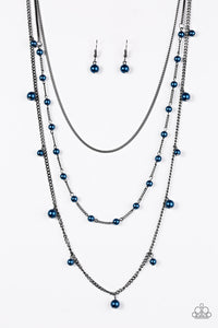 A glistening gunmetal chain gives way to layers of gunmetal chains featuring blue pearls. Varying in shape and shimmer, the mismatched chain drape across the chest in a refined fashion. Features an adjustable clasp closure.  Sold as one individual necklace. Includes one pair of matching earrings.