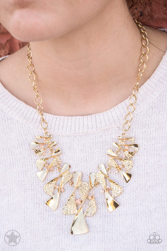Twisted gold hourglasses dance along a chunky gold chain with tiny peach rhinestones adding sparkling, elegant accents. Beautiful textured pieces add depth to the design. Features an adjustable clasp closure.  Sold as one individual necklace. Includes one pair of matching earrings.