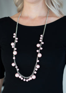 Varying in size, bubbly pink pearls trickle along a shimmery silver chain for a refined look. Features an adjustable clasp closure.  Sold as one individual necklace. Includes one pair of matching earrings. 