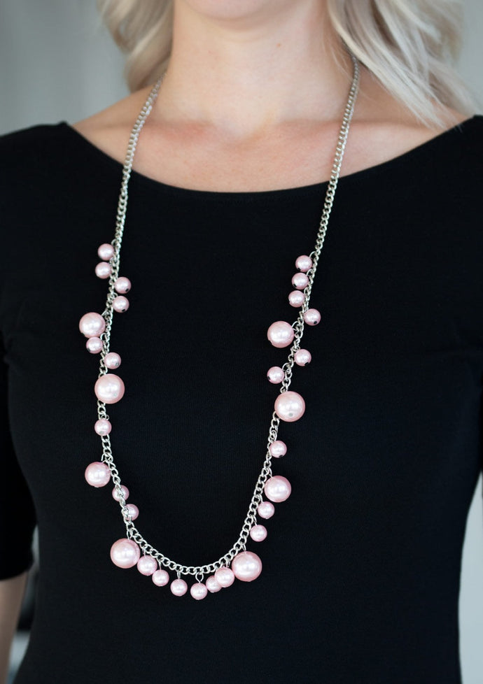 Varying in size, bubbly pink pearls trickle along a shimmery silver chain for a refined look. Features an adjustable clasp closure.  Sold as one individual necklace. Includes one pair of matching earrings. 