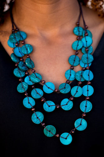 Tinted in blue finishes, shiny wooden discs trickle along shiny brown cording, creating three colorful layers below the collar. Features a button-loop closure.  Sold as one individual necklace. Includes one pair of matching  Always nickel and lead free.Tinted in blue finishes, shiny wooden discs trickle along shiny brown cording, creating three colorful layers below the collar. Features a button-loop closure.  Sold as one individual necklace. Includes one pair of matching