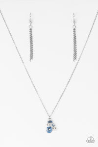 Varying in shape and size, glittery blue and white rhinestones coalesce into a sparkling pendant.