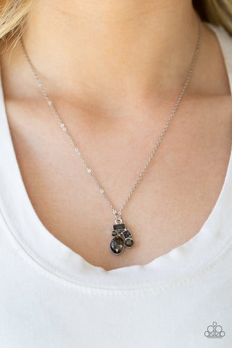 Varying in shape and size, smoky and hematite rhinestones coalesce into a sparkling pendant below the collar for a timeless look. Features an adjustable clasp closure.  Sold as one individual necklace. Includes one pair of matching earrings.  Always nickel and lead free.
