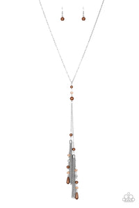 Dainty brown pearls and sparkling brown crystal-like beads give way to two shimmery silver chain tassels. Infused with ornate silver beads, strands of matching beads trickle down the tassels for a refined flair. Features an adjustable clasp closure.  Sold as one individual necklace. Includes one pair of matching earrings.  Always nickel and lead free.