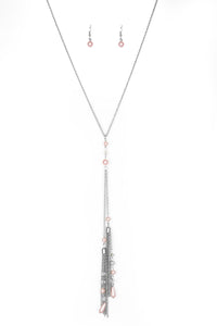 Dainty pink pearls and sparkling white crystal-like bead gives way to two shimmery silver chain tassels. Infused with ornate silver beads, strands of matching beads trickle down the tassels for a refined flair. Features an adjustable clasp closure.  Sold as one individual necklace. Includes one pair of matching earrings.