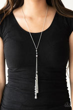 Load image into Gallery viewer, Dainty silver pearls and sparkling white crystal-like beads gives way to two shimmery silver chain tassels. Infused with ornate silver beads, strands of matching beads trickle down the tassels for a refined flair. Features an adjustable clasp closure.  Sold as one individual necklace. Includes one pair of matching earrings.  Always nickel and lead free.