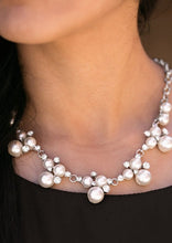 Load image into Gallery viewer, Clusters of pearls and dazzling white rhinestones join below the collar, creating refined frames. Infused with a glistening silver chain, the sections of luminescent frames trickle along the neck in a timeless fashion. Features an adjustable clasp closure.  Sold as one individual necklace. Includes one pair of matching earrings.