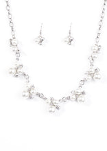 Load image into Gallery viewer, Clusters of pearls and dazzling white rhinestones join below the collar, creating refined frames. Infused with a glistening silver chain, the sections of luminescent frames trickle along the neck in a timeless fashion. Features an adjustable clasp closure.  Sold as one individual necklace. Includes one pair of matching earrings.