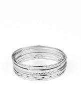 Load image into Gallery viewer, Featuring an array of smooth, hammered, and metallic rope-like textures, a mismatched collection of shiny silver bangles stacks across the wrist for a classic look.  Sold as one set of seven bracelets.  