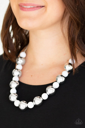 Polished white beads and dramatic silver beads drape below the collar for a perfect pop of color. Features an adjustable clasp closure.  Sold as one individual necklace. Includes one pair of matching earrings.  Always nickel and lead free.