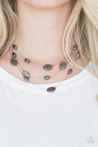 Featuring smooth and delicately hammered finishes, mismatched gunmetal beads are threaded along dainty silver wires, creating floating layers below the collar. Features an adjustable clasp closure.  Sold as one individual necklace. Includes one pair of matching earrings.  Always nickel and lead free.