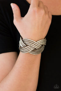 Oversized glassy white rhinestones are encrusted along strands of crisscrossing brown suede, creating a fierce shimmer around the wrist. Features an adjustable snap closure.  Sold as one individual bracelet.  Always nickel and lead free.