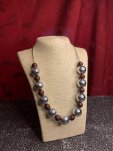 Load image into Gallery viewer, Polished brown beads and dramatic silver beads drape below the collar for a perfect pop of color. Features an adjustable clasp closure.  Sold as one individual necklace. Includes one pair of matching earrings.  Always nickel and lead free.