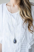 Load image into Gallery viewer, A glowing blue moonstone is pressed into an ornate teardrop frame radiating with floral detail. The dramatic pendant swings from the bottom of a lengthened silver chain for a whimsical finish. Features an adjustable clasp closure.  Sold as one individual necklace. Includes one pair of matching earrings.  Always nickel and lead free.