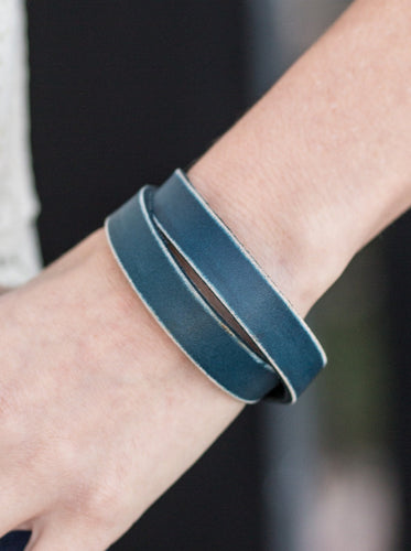 Brushed in a distressed finish, blue leather wraps around the wrist in an urban fashion. The elongated leather band allows for a trendy double wrap design. Features an adjustable snap closure.  Sold as one individual bracelet.