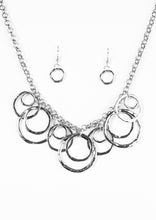 Load image into Gallery viewer, Featuring a subtle hammered finish, asymmetrical silver rings cascade from the bottom of a bold silver chain, creating a dizzying fringe below the collar. Features an adjustable clasp closure.  Sold as one individual necklace. Includes one pair of matching earrings.