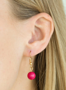 Varying in shape, glassy and polished pink beads swing from the bottom of interlocking gold chains. Crystal-like teardrops are sprinkled along the colorful beading, creating a flirtatious fringe below the collar. Features an adjustable clasp closure.  Sold as one individual necklace. Includes one pair of matching earrin