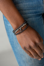 Load image into Gallery viewer, A collection of black stone beads and faceted silver beads are threaded along stretchy bands around the wrist, creating earthy layers.  Sold as one set of three bracelets.  Always nickel and lead free.
