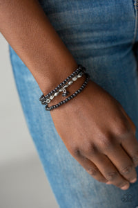 A collection of black stone beads and faceted silver beads are threaded along stretchy bands around the wrist, creating earthy layers.  Sold as one set of three bracelets.  Always nickel and lead free.