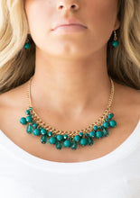 Load image into Gallery viewer, Varying in shape, glassy and polished Quetzal Green beads swing from the bottom of interlocking gold chains. Crystal-like teardrops are sprinkled along the colorful beading, creating a flirtatious fringe below the collar. Features an adjustable clasp closure.  Sold as one individual necklace. Includes one pair of matching earrings.  