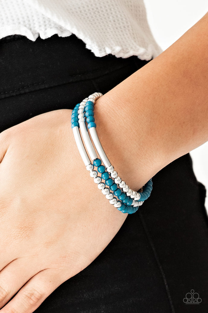 A collection of refreshing blue and shiny silver accents are threaded along a long wire to create an infinity wrap bracelet. Coil design allows for an adjustable fit.  Sold as one individual bracelet.  Always nickel and lead free.
