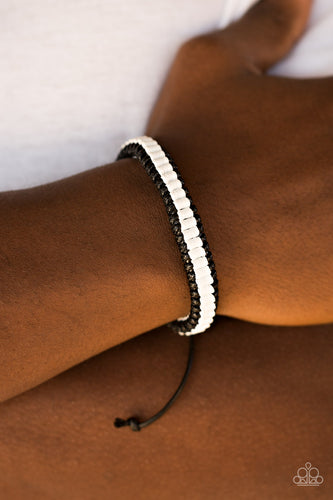 Black and white cording weaves into a knotted braid around the wrist for an urban look. Features an adjustable sliding knot closure.  Sold as one individual bracelet.  Always nickel and lead free.
