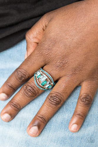 Blue rhinestone encrusted bands flank a row of emerald cut glass beads in shades of blue for a regal look. Features a stretchy band for a flexible fit.  Sold as one individual ring.  Always nickel and lead free.