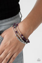Load image into Gallery viewer, Mismatched silver accents and disc shaped purple beading slides along stretchy spring-like wires for a spunky tribal look.  Sold as one set of four bracelets.  Always nickel and lead free.