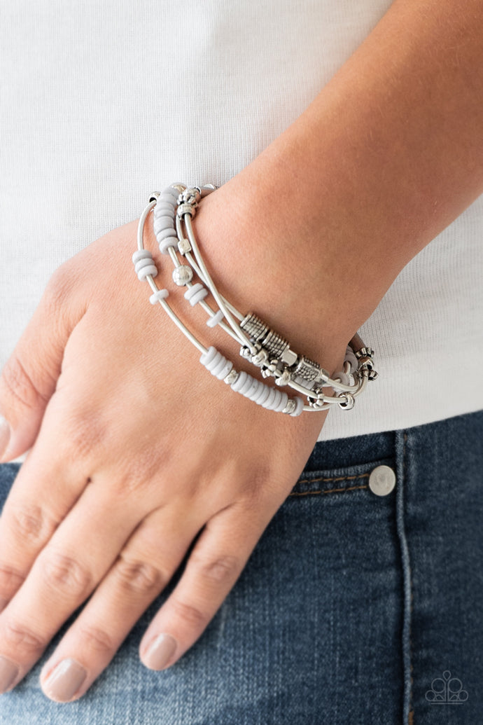 Mismatched silver accents and disc shaped gray beading slides along stretchy spring-like wires for a spunky tribal look.  Sold as one set of four bracelets.  Always nickel and lead free.
