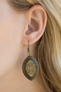 Featuring filigree filled details, a shimmery brass frame swings from the ear for a tribal inspired look. Earring attaches to a standard fishhook fitting.  Sold as one pair of earrings.  Always nickel and lead free.