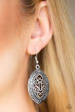 Load image into Gallery viewer, Featuring filigree filled details, a shimmery silver frame swings from the ear for a tribal inspired look. Earring attaches to a standard fishhook fitting.  Sold as one pair of earrings.  Always nickel and lead free.