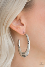 Load image into Gallery viewer, V-shaped geometric patterns are stamped along a flat silver hoop for a bold, tribal inspired look. Earring attaches to a standard post fitting. Hoop measures 1 1/4&quot; in diameter.  Sold as one pair of hoop earrings.  Always nickel and lead free.