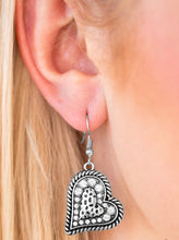 Load image into Gallery viewer, Encrusted in glittery white rhinestones, the center of a heart shaped frame is embossed in a textured heart for a flirty finish. Earring attaches to a standard fishhook fitting.  Sold as one pair of earrings.
