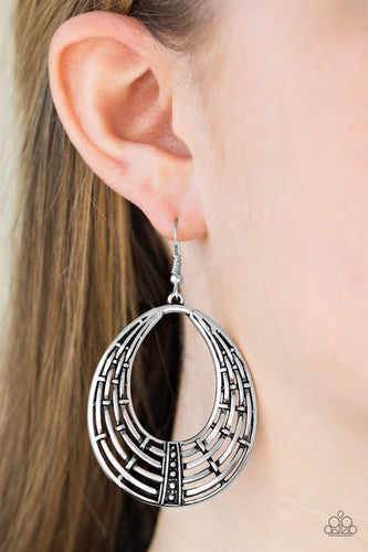 Brushed in an antiqued shimmer, glistening silver bars weave into a rustic teardrop. A row of shimmery silver studs are pressed down the bottom of the teardrop for a tactile finish. Earring attaches to a standard fishhook fitting.  Sold as one pair of earrings.  Always nickel and lead free.
