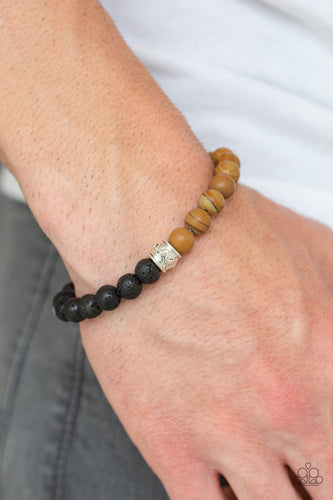 A collection of black lava rock beads, brown stone beads, and ornate silver accents are threaded along a stretchy band around the wrist for a seasonal look.  Sold as one individual bracelet.  Always nickel and lead free. 