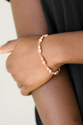 Varying in size, pairs of glassy peach rhinestones are encrusted along shiny copper frames and linked around the wrist for a timeless finish. Features an adjustable clasp closure.  Sold as one individual bracelet.  Always nickel and lead free.
