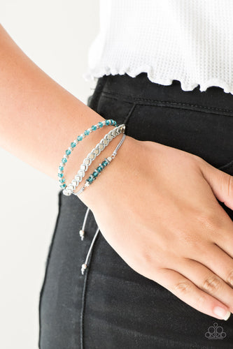 Infused with a strand of faceted blue and classic silver beads, shiny gray cording knots around mismatched beads for an edgy look. Features an adjustable sliding knot closure.  Sold as one individual bracelet.  Always nickel and lead free.