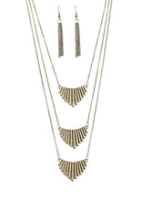 Load image into Gallery viewer, Brushed in an antiqued shimmer, flared brass plates trickle down the chest in a fierce fashion. The tribal inspired frames layer down the chest, effortlessly elongating the torso for a flawless finish. Features an adjustable clasp closure.  Sold as one individual necklace. Includes one pair of matching earrings.