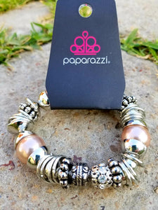 A mishmash of bold silver rings, refreshing brown pearls, and ornate silver beads accents are threaded along a stretchy elastic band.  White rhinestone encrusted beads are sprinkled between for a sparkling finish.  Sold as one individual bracelet.  By Paparazzi Accessories.  EXCLUSIVE~