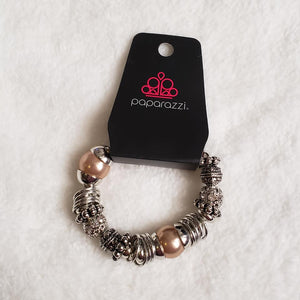 A mishmash of bold silver rings, refreshing brown pearls, and ornate silver beads accents are threaded along a stretchy elastic band. White rhinestone encrusted beads are sprinkled between for a sparkling finish. Sold as one individual bracelet. By Paparazzi Accessories. EXCLUSIVE~