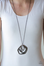 Load image into Gallery viewer, A collection of hammered geometric frames swing from the bottom of a lengthened gunmetal chain, creating a bold artisan inspired pendant. Features an adjustable clasp closure.  Sold as one individual necklace. Includes one pair of matching earrings.   Always nickel and lead free.