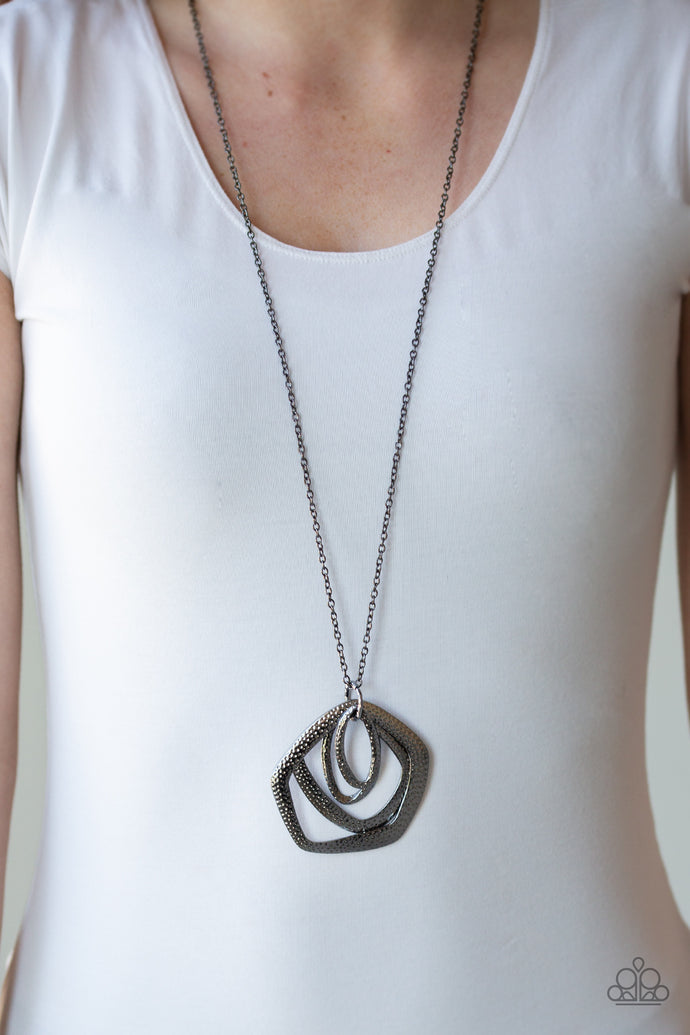 A collection of hammered geometric frames swing from the bottom of a lengthened gunmetal chain, creating a bold artisan inspired pendant. Features an adjustable clasp closure.  Sold as one individual necklace. Includes one pair of matching earrings.   Always nickel and lead free.
