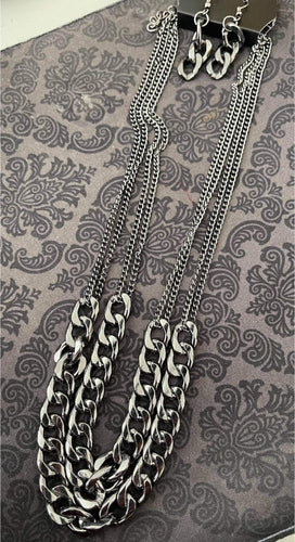 A double layer of large gunmetal chain create an edgy look.  Sold as one individual necklace. Includes one pair of matching earrings.  Always nickel and lead free.  Fashion Fix Exclusive March 2021