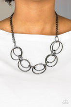 Load image into Gallery viewer, Doubled gunmetal hoops link below the collar for a bold industrial look. Features an adjustable clasp closure.  Sold as one individual necklace. Includes one pair of matching earrings.  Always nickel and lead free.
