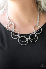 Load image into Gallery viewer, Doubled silver hoops link below the collar for a bold industrial look. Features an adjustable clasp closure.  Sold as one individual necklace. Includes one pair of matching earrings.  Always nickel and lead free.